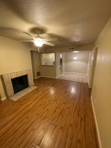 a view of a room with wooden floor