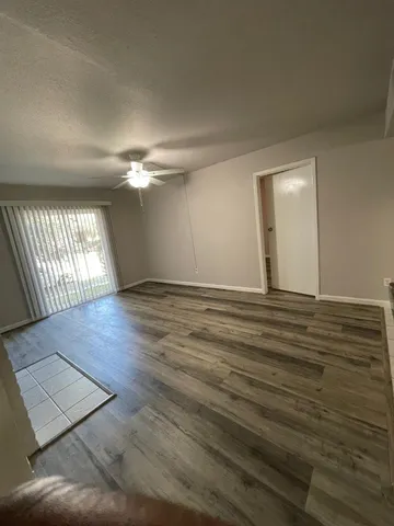 wooden floor in an empty room with a window
