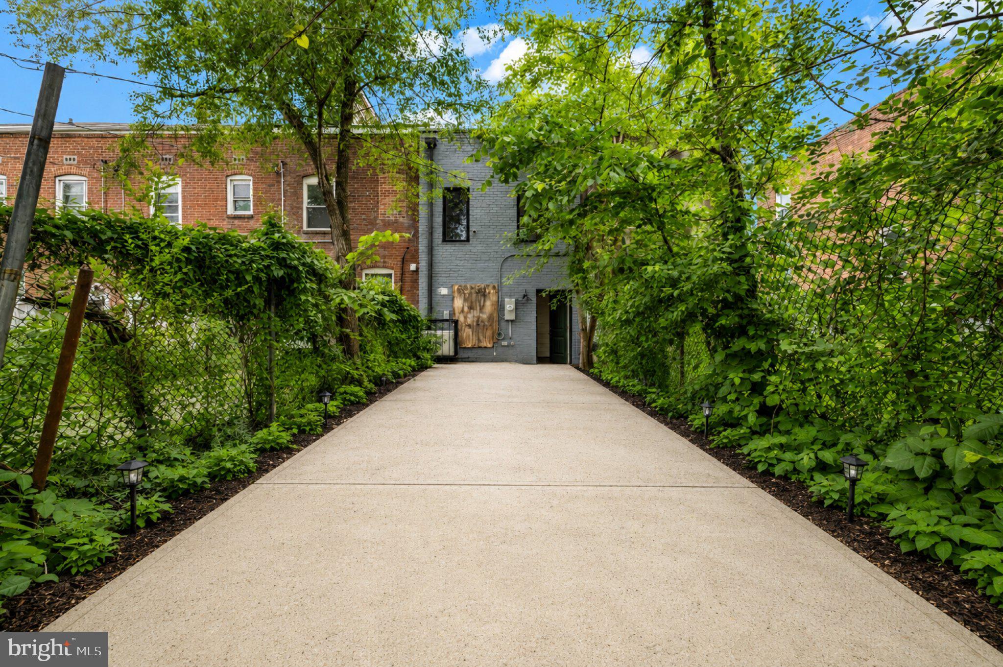 2731 Round Road Baltimore, MD 21225 - Photo 12 of 26 Charming pathway through lush greenery.