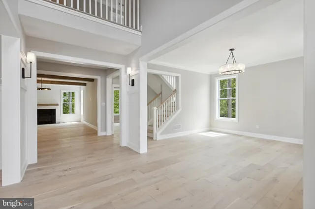 wooden floor fireplace and windows in an empty room