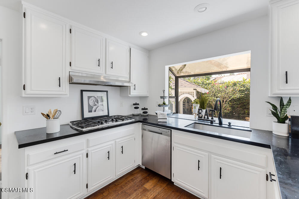 4035 Cliffrose Avenue Moorpark, CA 93021 - Photo 12 of 43 a kitchen with granite countertop white cabinets white appliances and a wide window