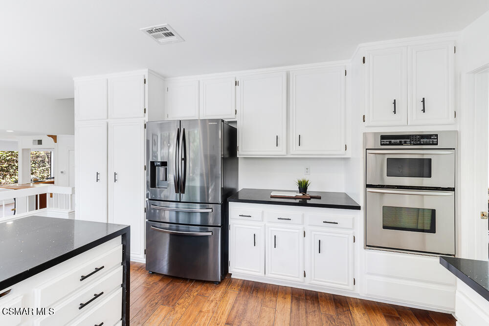 4035 Cliffrose Avenue Moorpark, CA 93021 - Photo 13 of 43 a kitchen with granite countertop white cabinets and stainless steel appliances