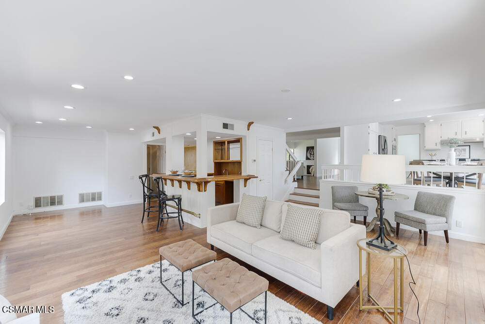 4035 Cliffrose Avenue Moorpark, CA 93021 - Photo 16 of 43 a living room with furniture and a dining table with kitchen view