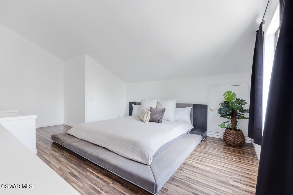 4035 Cliffrose Avenue Moorpark, CA 93021 - Photo 22 of 43 a bedroom with a bed and a potted plant