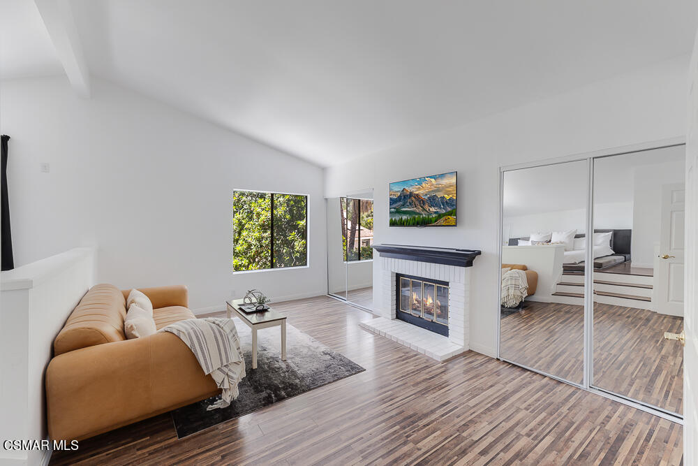 4035 Cliffrose Avenue Moorpark, CA 93021 - Photo 23 of 43 a living room with furniture a fireplace and a flat screen tv