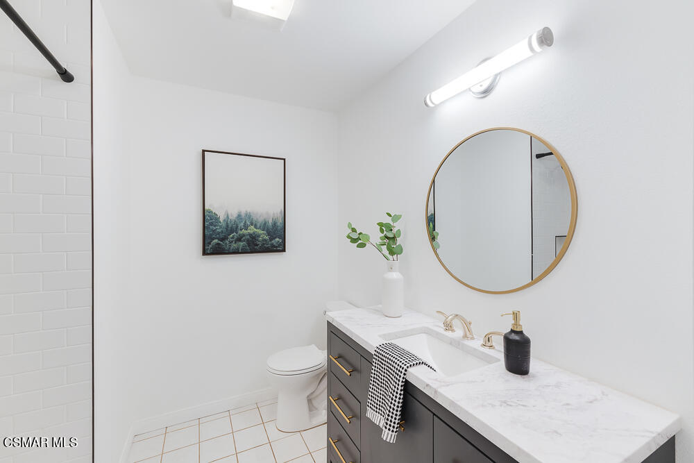4035 Cliffrose Avenue Moorpark, CA 93021 - Photo 27 of 43 a bathroom with a granite countertop sink and a mirror