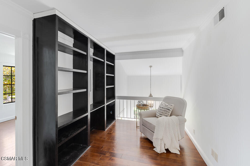 4035 Cliffrose Avenue Moorpark, CA 93021 - Photo 29 of 43 a living room with a furniture and a book shelf