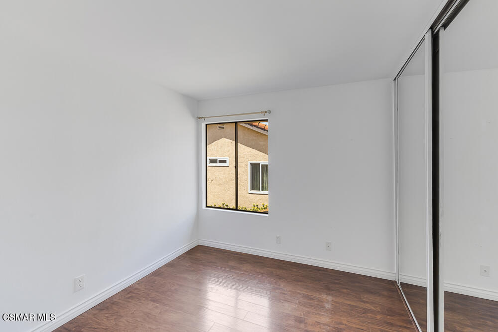 4035 Cliffrose Avenue Moorpark, CA 93021 - Photo 30 of 43 an empty room with wooden floor and windows