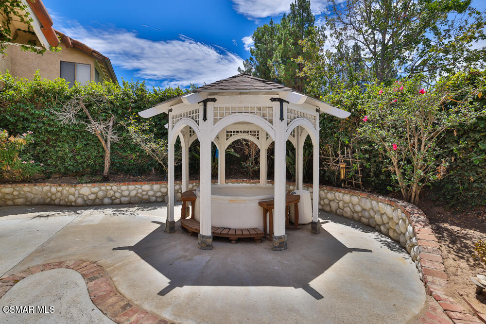 4035 Cliffrose Avenue Moorpark, CA 93021 - Photo 39 of 43 a view of a white house with many windows plants and large tree