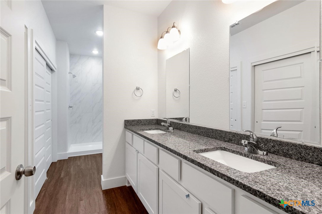 1920 Royal Loop Belton, TX 76513 - Photo 12 of 15 a bathroom with a granite countertop double vanity sink and mirror