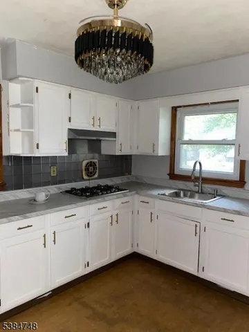 a kitchen with stainless steel appliances granite countertop a sink a stove and a microwave