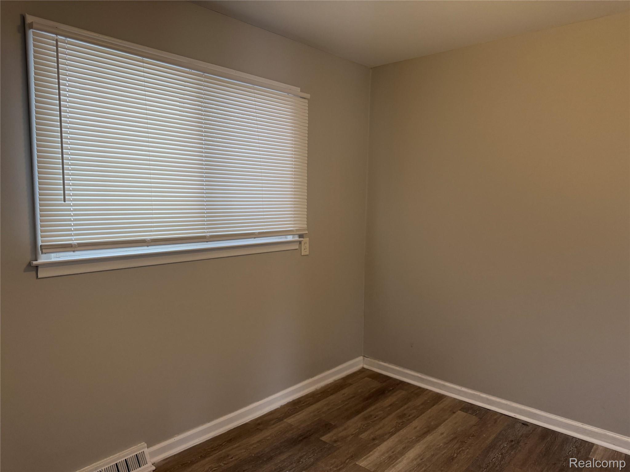6237 Inkster Road Taylor, MI 48180 - Photo 7 of 14 Wood-finish flooring, neutral wall color, and white trim