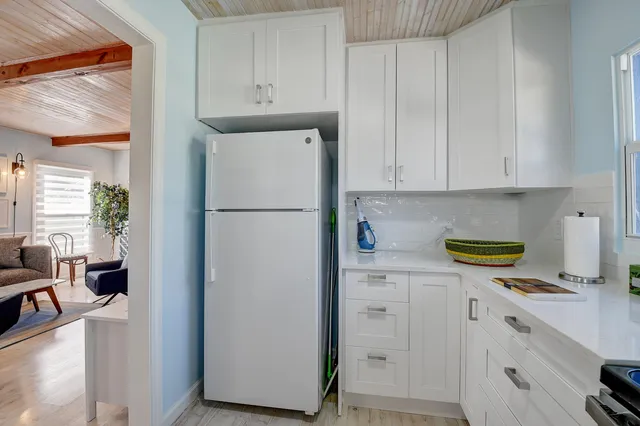 a kitchen with refrigerator and cabinets