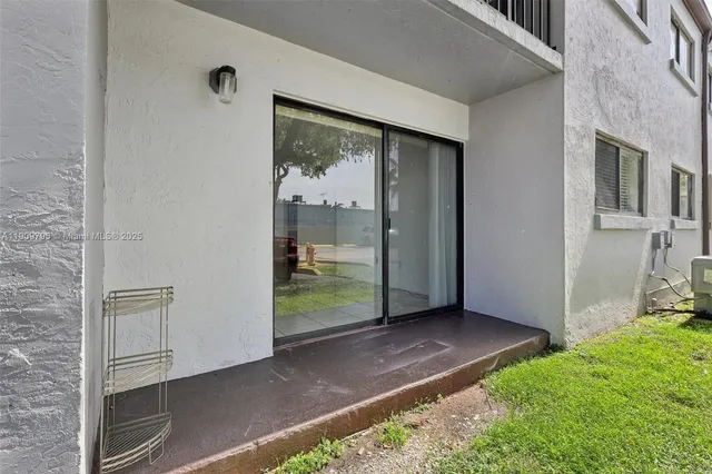 a view of outdoor space with sliding door and wooden floor