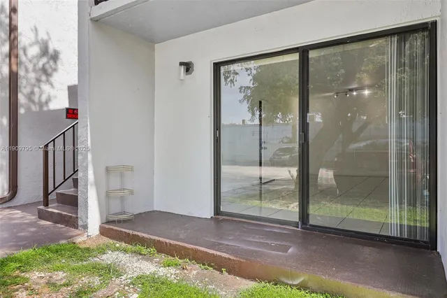a view of backyard with tub and door
