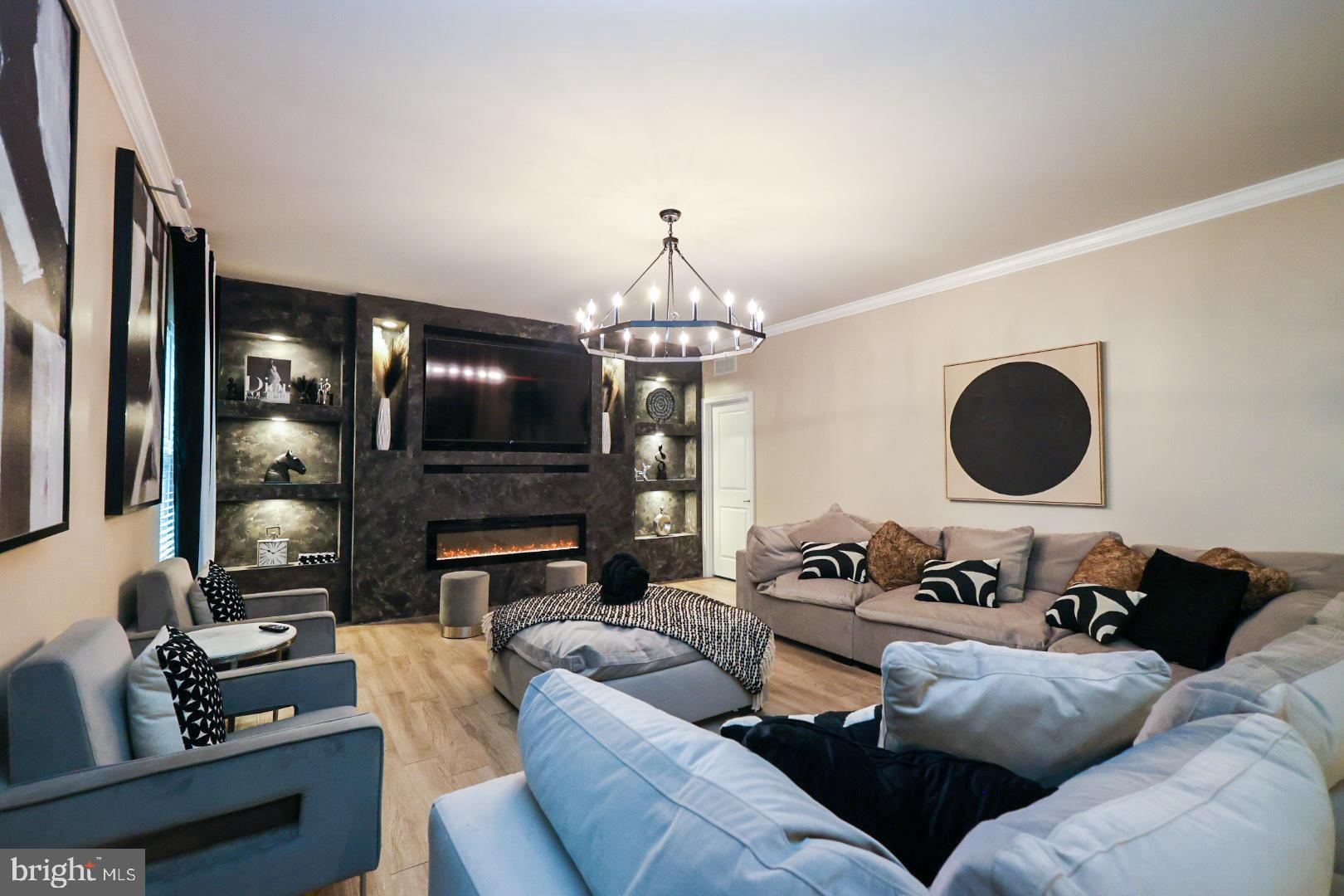 152 Tywyn Drive Middletown, DE 19709 - Photo 5 of 25 a living room with furniture a fireplace and a flat screen tv