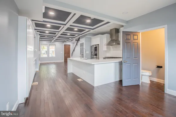a view of a room with wooden floor and window