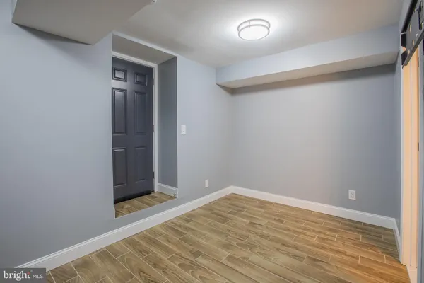 a view of a room with wooden floor