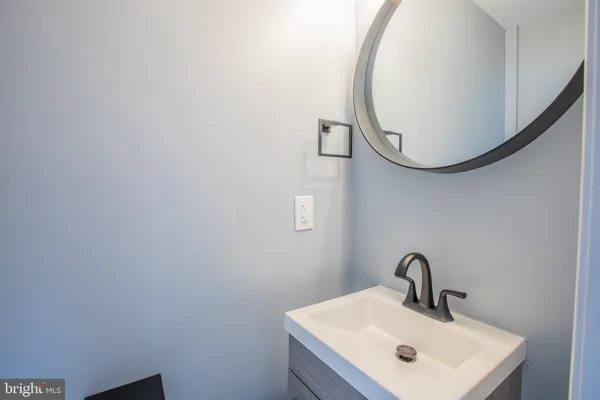 a bathroom with a toilet a sink a vanity and mirror