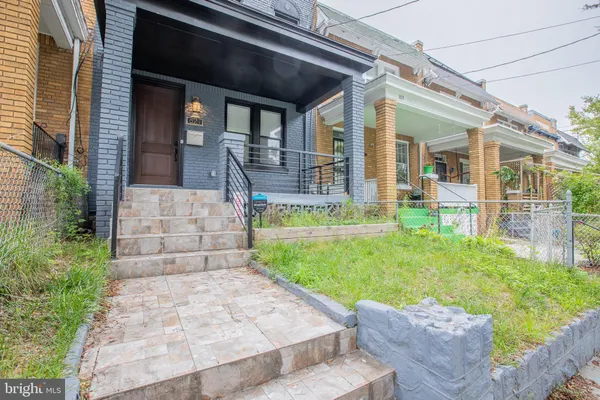 a view of a house with a small yard and plants