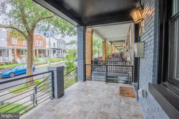 a view of a porch with plants and wooden fence