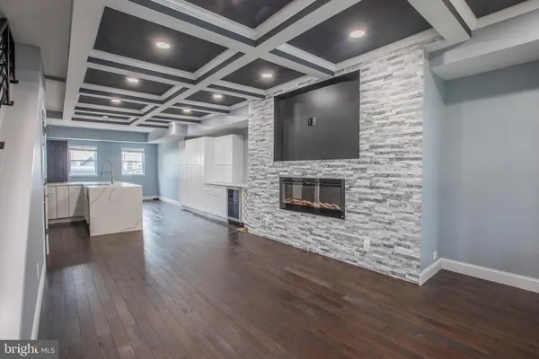 a living room with hard wood floors and a fireplace