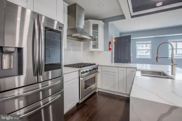 a kitchen with stainless steel appliances a refrigerator and a sink