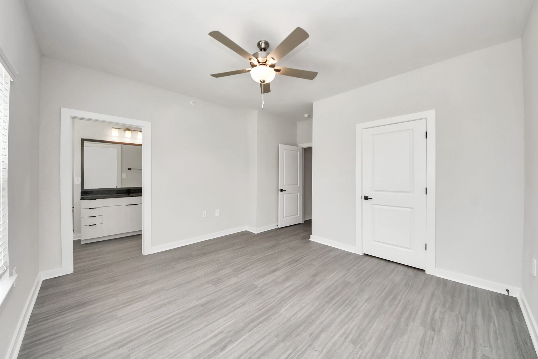 7711 Longmire Road, Unit 102 Conroe, TX 77304 - Photo 16 of 48 Primary Suite offers walk-closet,bath w/granite vanity&lux tub/shower.