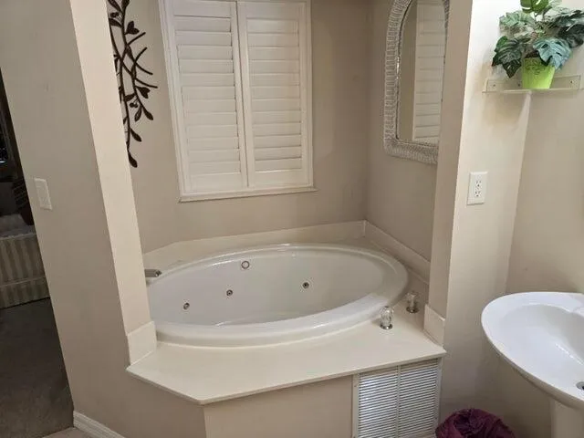 a white bath tub sitting next to a white toilet