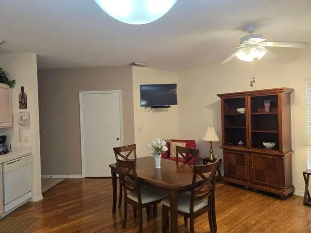 a view of a dining room with furniture and wooden floor