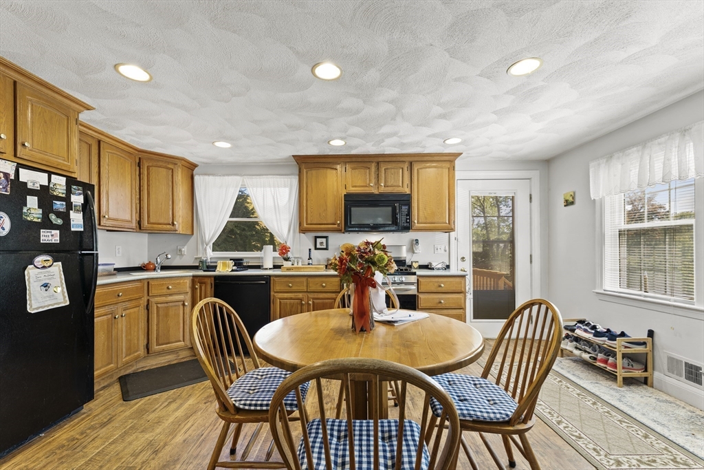 85 Oak Street Stoneham, MA 02180 - Photo 12 of 35 a dining room with furniture a window and stainless steel appliances