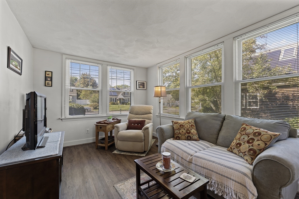 85 Oak Street Stoneham, MA 02180 - Photo 15 of 35 a living room with furniture a flat screen tv and a large window