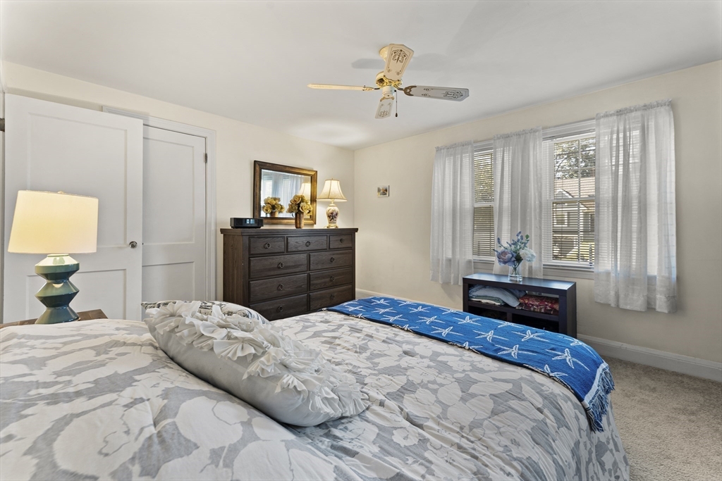 85 Oak Street Stoneham, MA 02180 - Photo 18 of 35 a bedroom with a bed and wooden floor