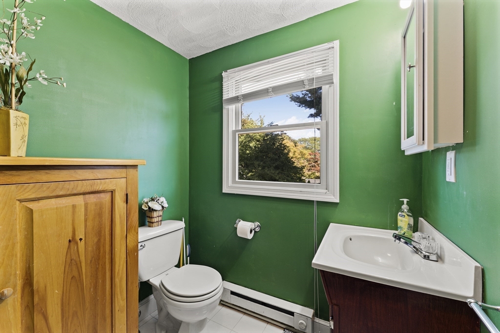 85 Oak Street Stoneham, MA 02180 - Photo 25 of 35 a bathroom with a toilet sink and mirror