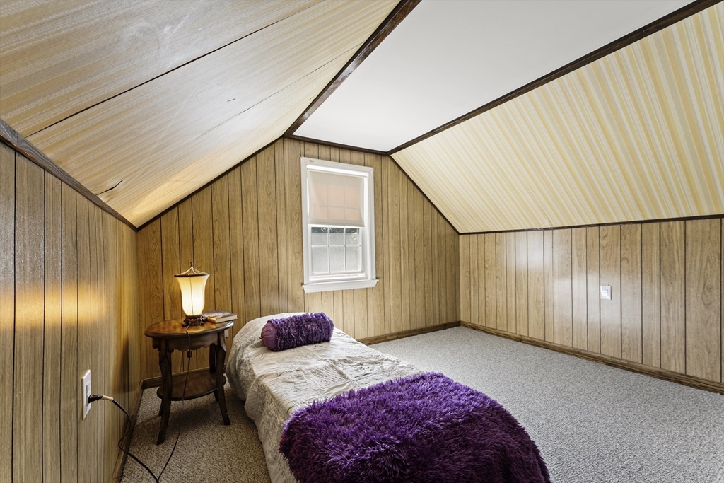 85 Oak Street Stoneham, MA 02180 - Photo 27 of 35 a bedroom with a bed and a table