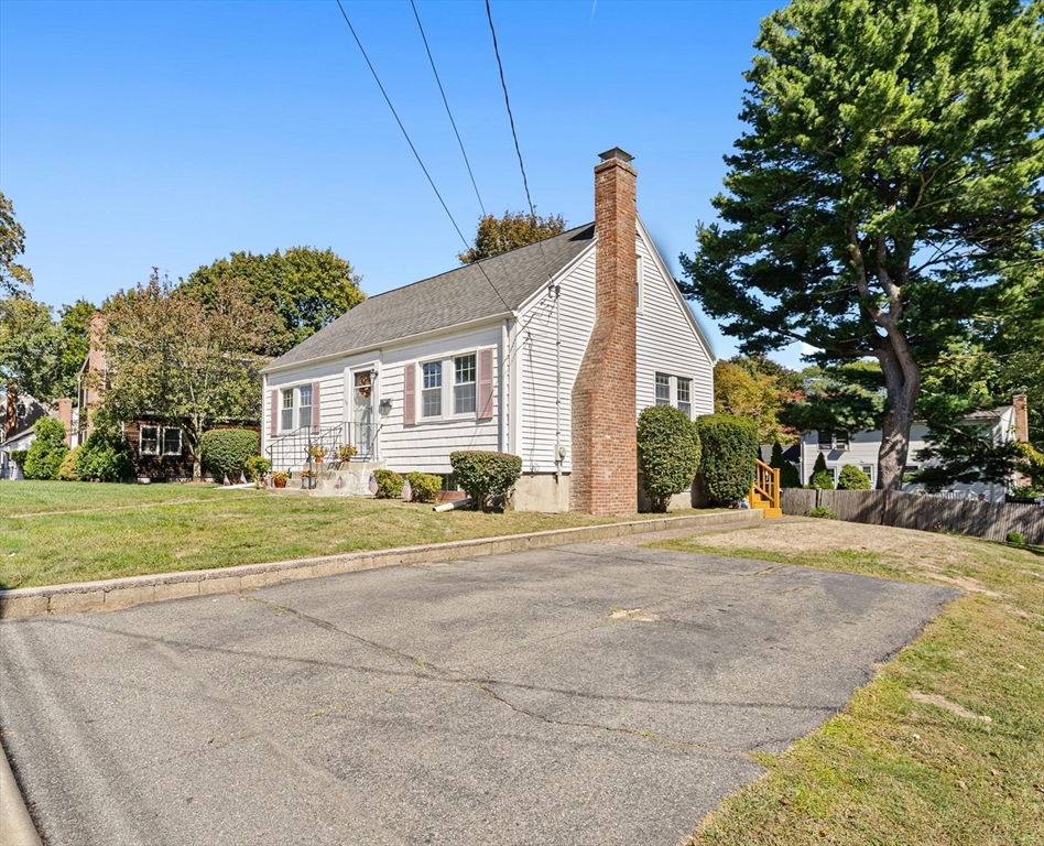 85 Oak Street Stoneham, MA 02180 - Photo 4 of 35 a front view of a house with a yard and garage
