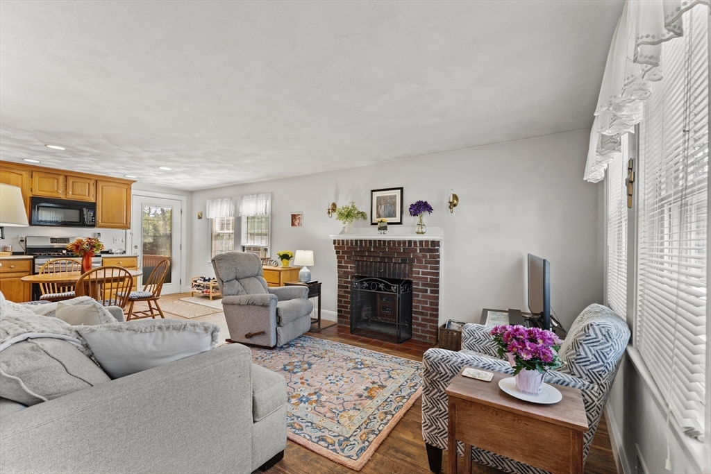 85 Oak Street Stoneham, MA 02180 - Photo 6 of 35 a living room with furniture and a fireplace