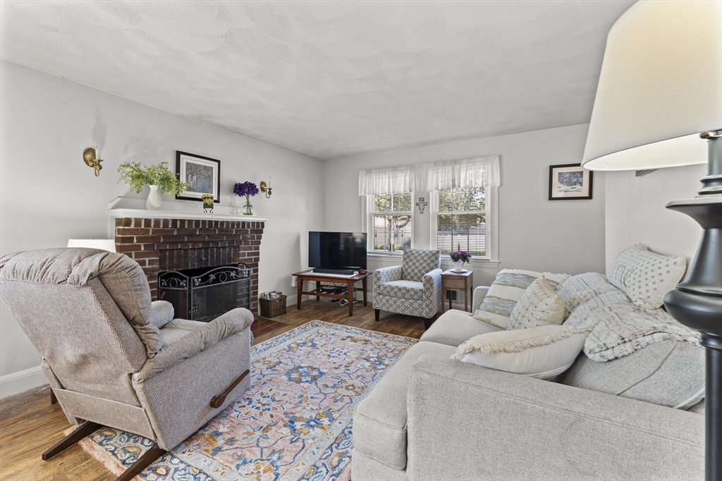 85 Oak Street Stoneham, MA 02180 - Photo 8 of 35 a living room with furniture a couch and a fireplace