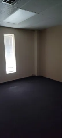 a view of a livingroom with wooden floor and a window