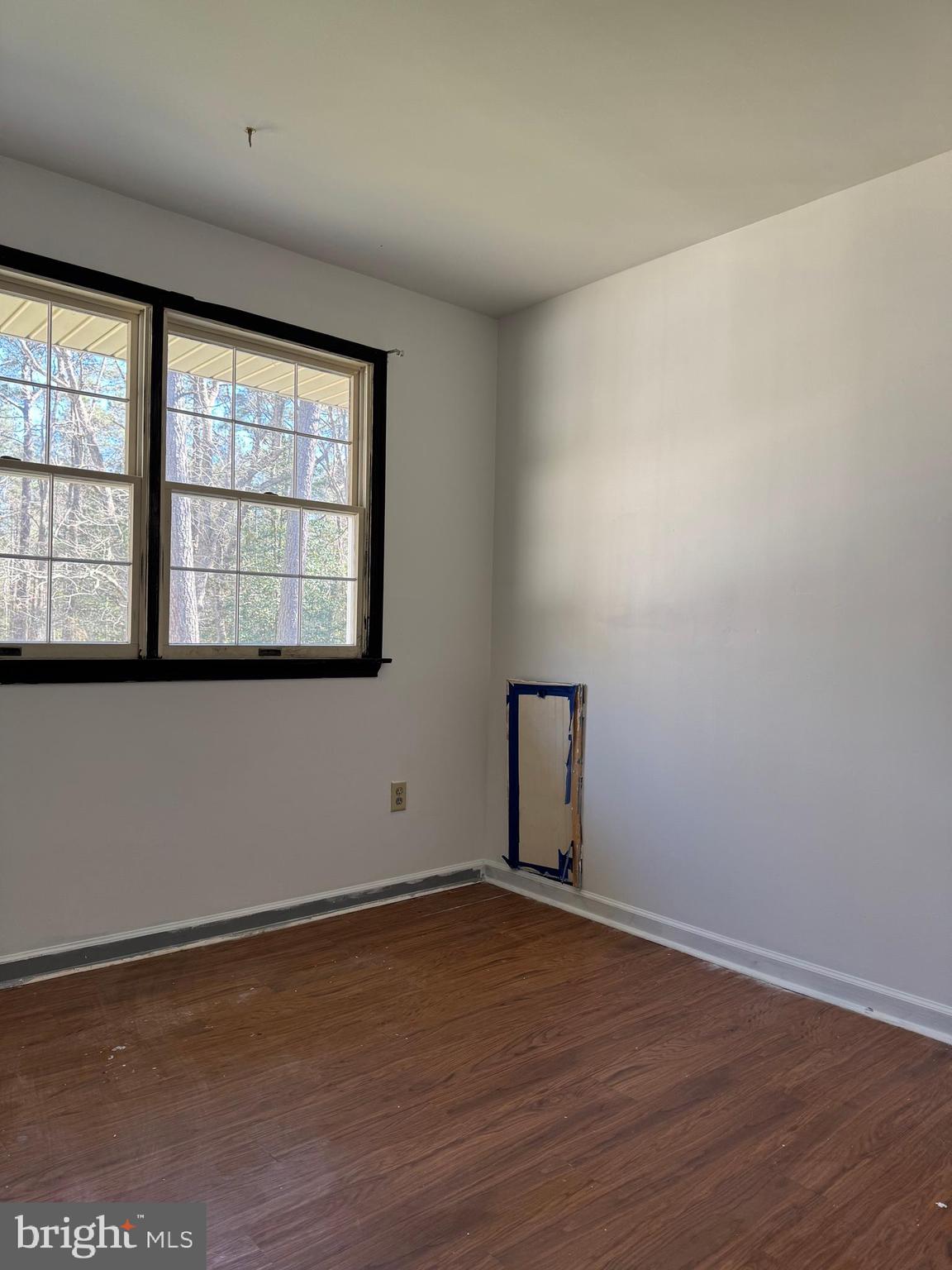 31939 Downing Road Delmar, MD 21875 - Photo 29 of 34 an empty room with wooden floor and windows