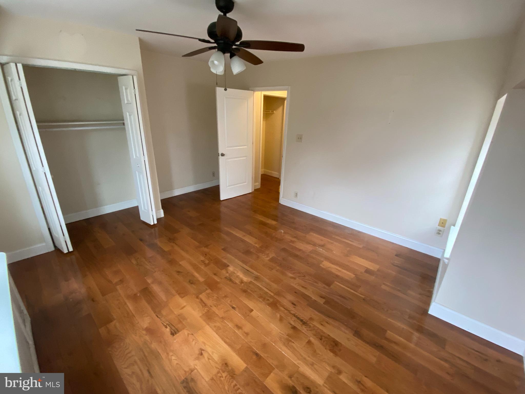 4616 Cedar Avenue, Unit 3 Philadelphia, PA 19143 - Photo 2 of 8 wooden floor in an empty room