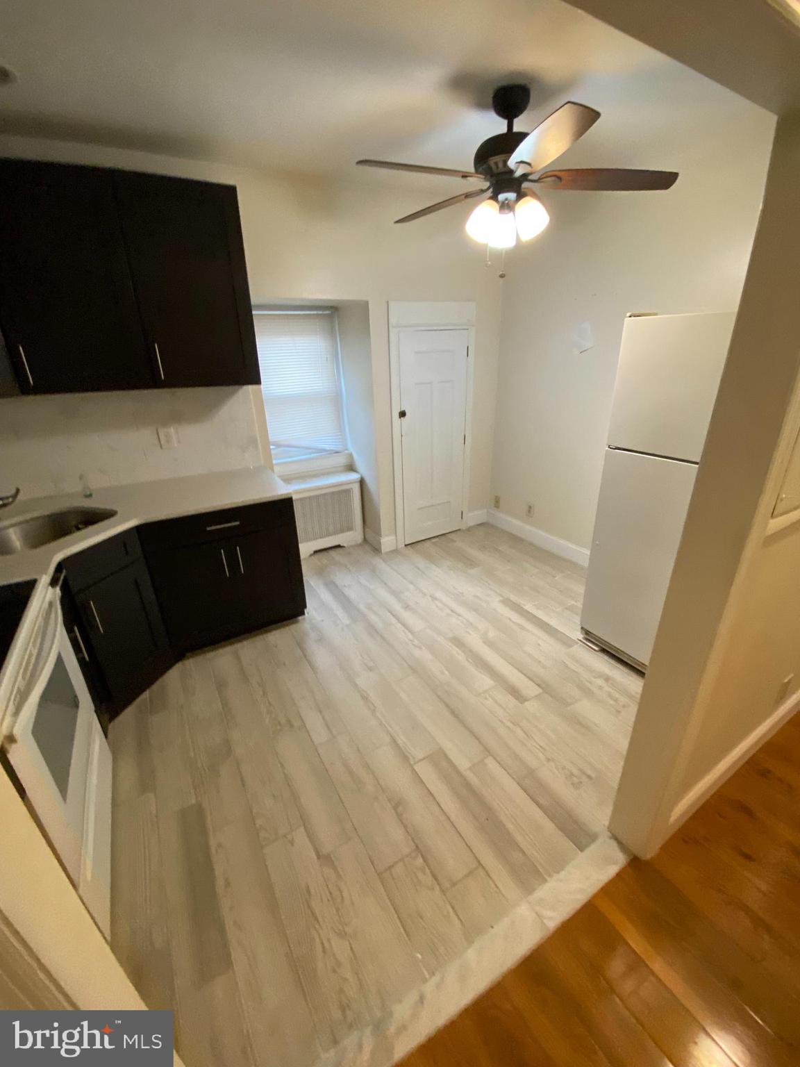 4616 Cedar Avenue, Unit 3 Philadelphia, PA 19143 - Photo 4 of 8 a bedroom with a bed and a cabinets