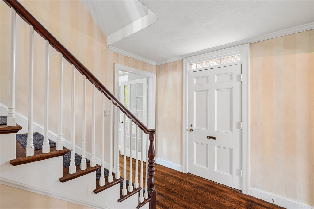 26 Pickwick Road Marblehead, MA 01945 - Photo 5 of 40 a view of a hallway with wooden floor and staircase