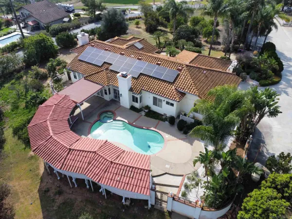 an aerial view of a house with garden space and street view