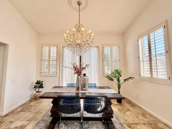 a dining room with furniture window and wooden floor