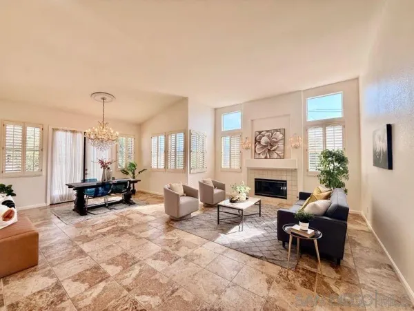 a living room with furniture large window and fireplace