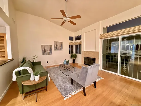 a living room with furniture a fireplace and a flat screen tv