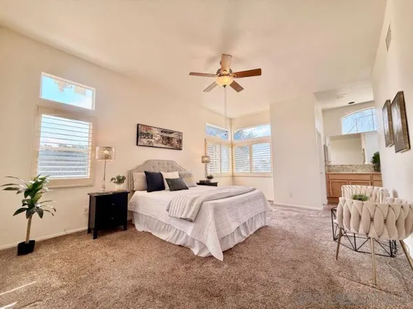 a bathroom with a granite countertop sink and a bathtub