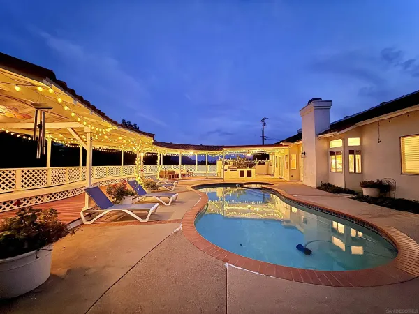 a view of a swimming pool with sitting area