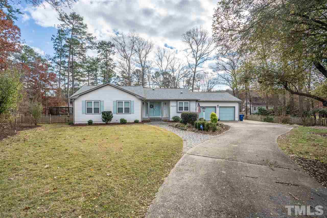 5400 Chilham Place Raleigh, NC 27612 - Photo 1 of 25 a front view of a house with a yard and garage